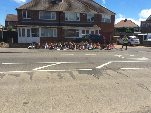 Class sitting outside the house we looked at on maps and census data